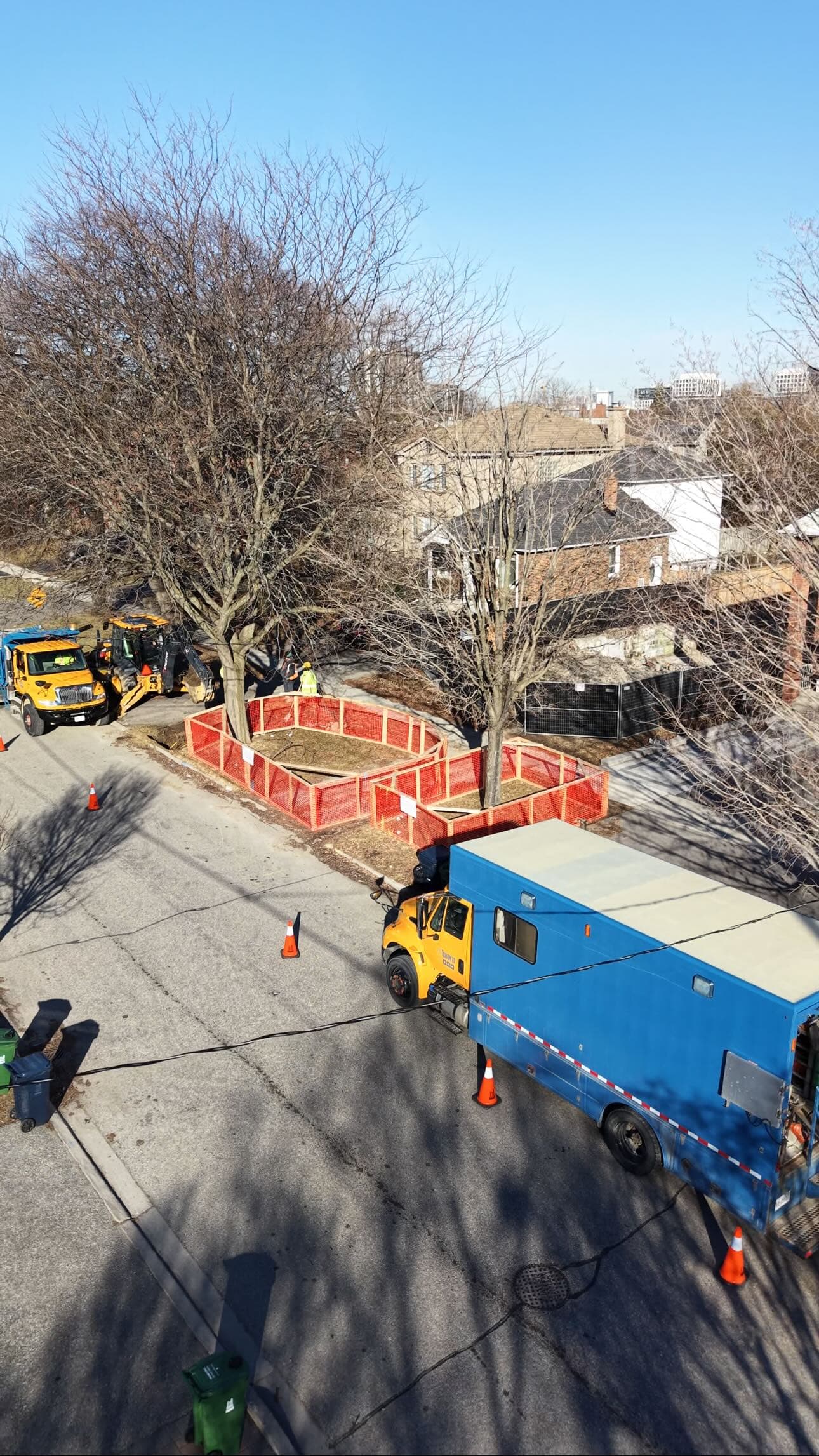 Toronto residential site with city work vehicles and tree protection fencing, related to fire access and hydrant planning